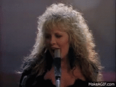 A Woman Singing Into A Microphone With Makeagif.com Written On The Bottom GIF