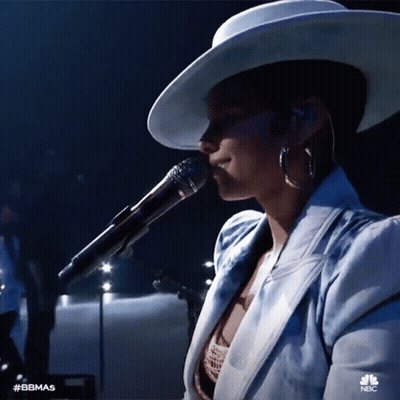 A Woman Singing Into A Microphone With The Hashtag #Bbmas On The Bottom Right GIF