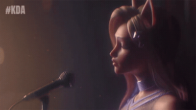 A Woman Singing Into A Microphone With The Hashtag #Kda Behind Her GIF
