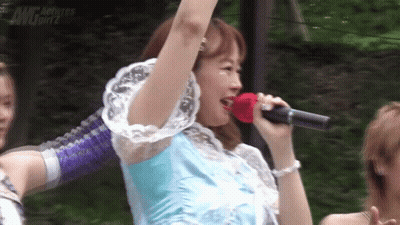 A Woman Singing Into A Microphone With The Word Actress Girlz In The Corner GIF