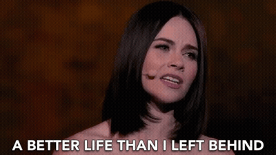 A Woman Singing Into A Microphone With The Words " A Better Life Than I Left Behind " Behind Her GIF