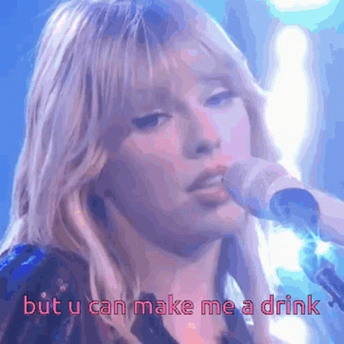 A Woman Singing Into A Microphone With The Words " But U Can Make Me A Drink " Below Her GIF