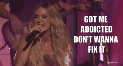 A Woman Singing Into A Microphone With The Words Got Me Addicted Don 'T Wanna Fix It Above Her GIF
