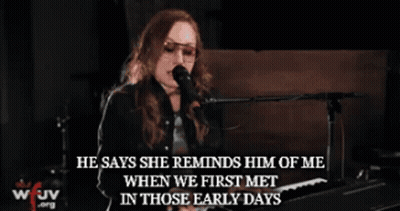 A Woman Singing Into A Microphone With The Words " He Says She Reminds Him Of Me " GIF