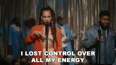 A Woman Singing Into A Microphone With The Words " I Lost Control Over All My Energy " Behind Her GIF