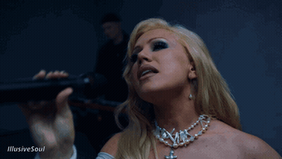 A Woman Singing Into A Microphone With The Words Illusive Soul On The Bottom Right GIF