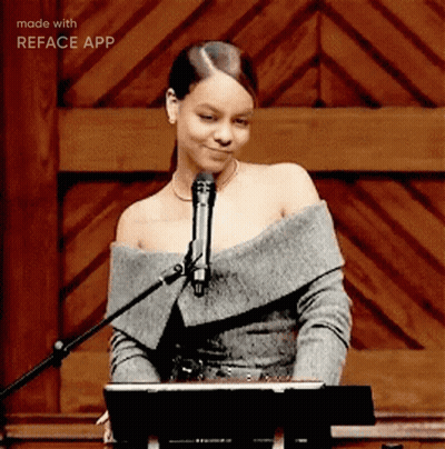 A Woman Singing Into A Microphone With The Words Made With Reface App Visible GIF