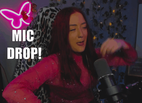 A Woman Singing Into A Microphone With The Words " Mic Drop " Behind Her GIF