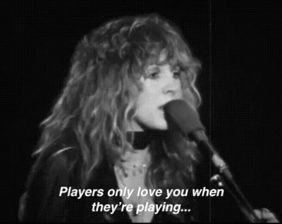 A Woman Singing Into A Microphone With The Words `` Players Only Love You When They 'Re Playing ... '' GIF