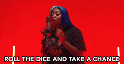 A Woman Singing Into A Microphone With The Words " Roll The Dice And Take A Chance " Below Her GIF