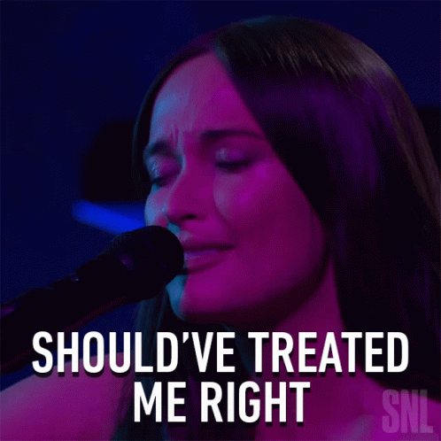 A Woman Singing Into A Microphone With The Words Should Ve Treated Me Right Above Her GIF