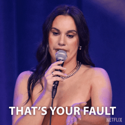 A Woman Singing Into A Microphone With The Words That 'S Your Fault On The Bottom Right GIF