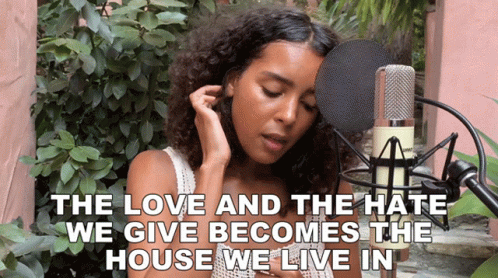 A Woman Singing Into A Microphone With The Words " The Love And The Hate We Give Becomes The House We Live In " Below He GIF