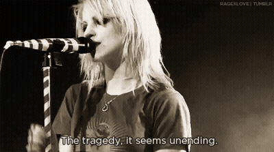 A Woman Singing Into A Microphone With The Words " The Tragedy It Seems Unending " GIF