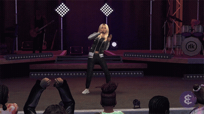 A Woman Singing On A Stage In Front Of A Drum Set That Says Rk GIF