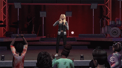 A Woman Singing On A Stage With A Nk Logo In The Corner GIF