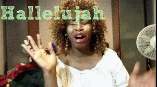 A Woman Singing The Song Hallelujah With A Fan In The Background GIF