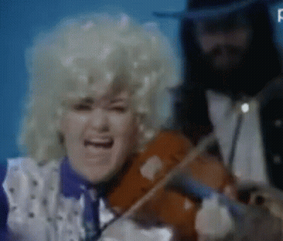 A Woman Singing While A Man Plays The Violin GIF