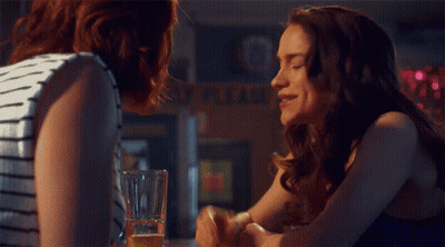 A Woman Sits At A Bar With A Sign That Says This Is What You Get When You 'Re Friends GIF