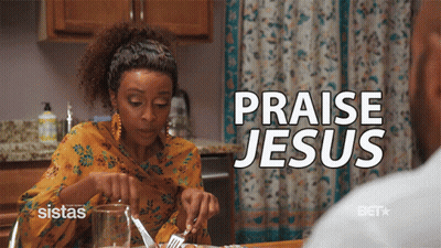 A Woman Sits At A Table With A Knife And Fork And The Words Praise Jesus Above Her GIF