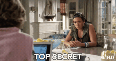 A Woman Sits At A Table With A Netflix Logo On The Bottom GIF