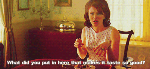 A Woman Sits At A Table With A Plate Of Food And Says What Did You Put In Here That Makes It Taste So Good .. GIF