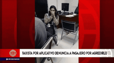 A Woman Sits In A Chair In Front Of A Desk With A Red Background That Says Taxista GIF