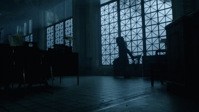 A Woman Sits In A Chair In Front Of A Large Window GIF