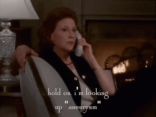 A Woman Sits In A Chair Talking On A Cell Phone And The Words In Our Medical Dictionary To See If I Just Had One GIF