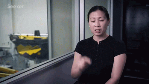 A Woman Sits In Front Of A Window With The Words See Cer On The Bottom GIF