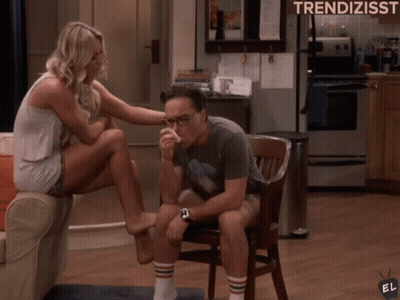 A Woman Sits On A Couch While A Man Sits In A Chair With The Words Trendizisst Written On The Bottom GIF
