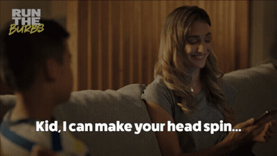 A Woman Sits On A Couch With A Child And Says " Kid I Can Make Your Head Spin ... " GIF