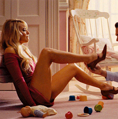 A Woman Sits On The Floor With Her Legs Crossed GIF