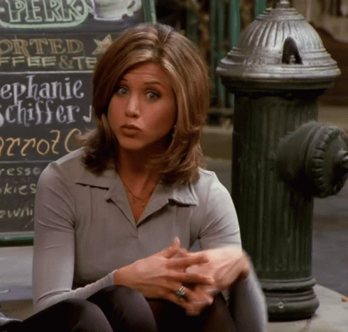 A Woman Sits On The Sidewalk In Front Of A Sign That Says " Perks " GIF