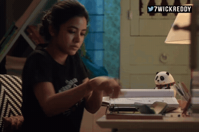A Woman Sitting At A Desk With 7Wickreddy Written On The Top Right GIF
