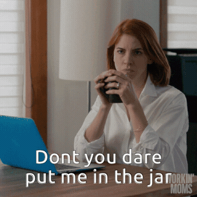 A Woman Sitting At A Desk With A Laptop And A Cup Of Coffee Says " Dont You Dare Put Me In The Jar GIF