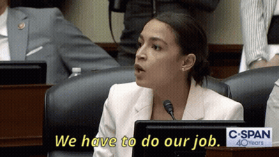 A Woman Sitting At A Desk With A Sign That Says C Span 40 Years GIF