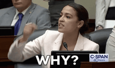 A Woman Sitting At A Desk With A Sign That Says " Why " GIF