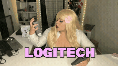 A Woman Sitting At A Desk With The Word Logitech In Pink GIF