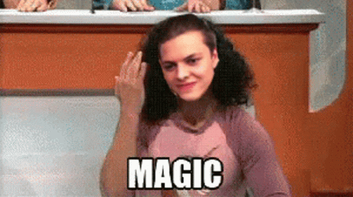 A Woman Sitting At A Desk With The Word Magic Written On Her Shirt GIF