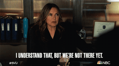 A Woman Sitting At A Desk With The Words I Understand That But We 'Re Not There Yet Written Below Her GIF