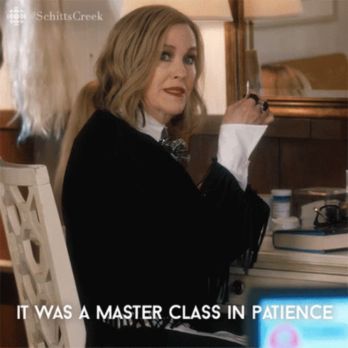 A Woman Sitting At A Desk With The Words It Was A Master Class In Patience On The Bottom GIF
