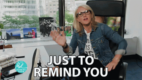 A Woman Sitting At A Desk With The Words Just To Remind You GIF