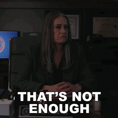 A Woman Sitting At A Desk With The Words That 'S Not Enough GIF