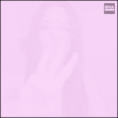 A Woman Sitting At A Table Making A Peace Sign GIF