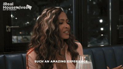 A Woman Sitting At A Table With A Glass Of Water And The Words Such An Amazing Experience On The Bottom GIF