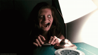 A Woman Sitting At A Table With A Lamp And A Roll Of Samuel 'S Tape On It GIF