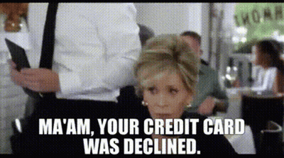 A Woman Sitting At A Table With A Man Holding A Credit Card And A Caption That Says Ma 'Am GIF