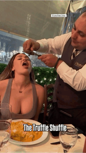 A Woman Sitting At A Table With A Plate Of Food And A Caption That Says The Truffle Shuffle GIF