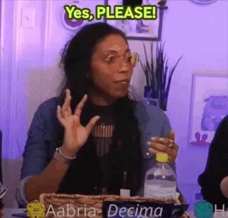A Woman Sitting At A Table With A Sign That Says Aabra Decima GIF